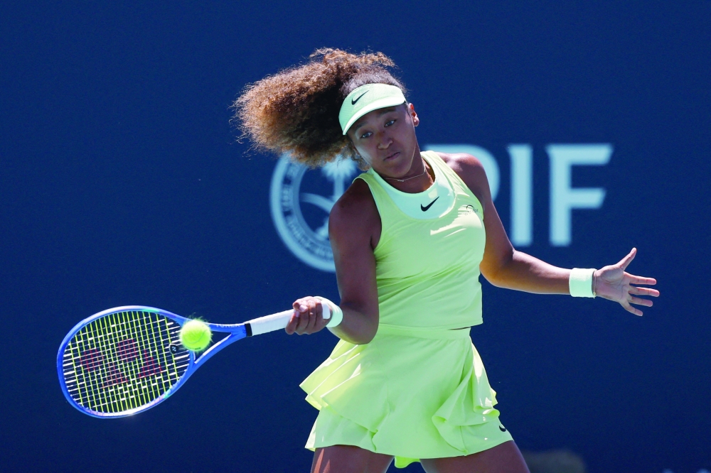 Osaka hits a forehand against Yulia (UKR).  — Reuters