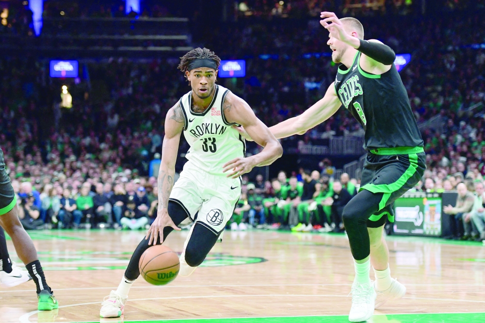 Brooklyn Nets centre Nic Claxton (33) controls the ball while Boston Celtics centre Kristaps Porzingis (8) defends during the first half at TD Garden. — Reuters
