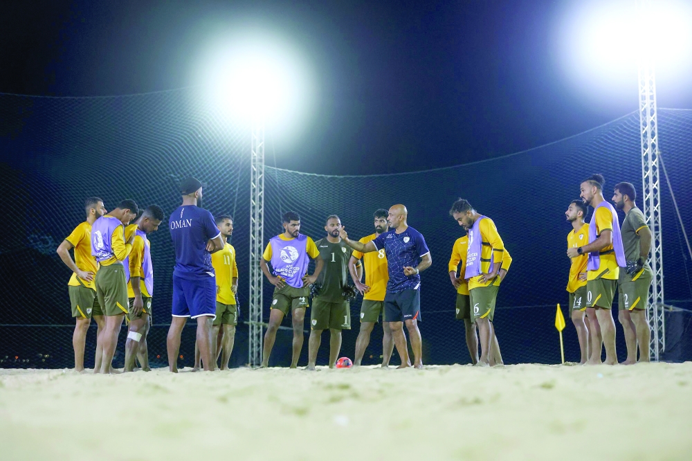 Oman coach Talib Hilal with the players during training.