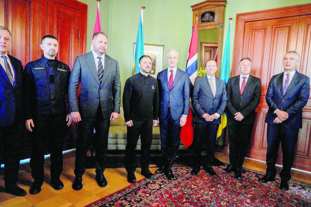 Ukraine's President Zelensky and Norway's Prime Minister Jonas Gahr Store (4th R) pose with their delegations including Norway's Foreign Minister Espen Barth Eide, Norway's Defence Minister Tore Sandvik (2nd R) and Norway's Finance Minister Jens Stoltenberg (R) at the Prime Minister's residence in Oslo. - AFP