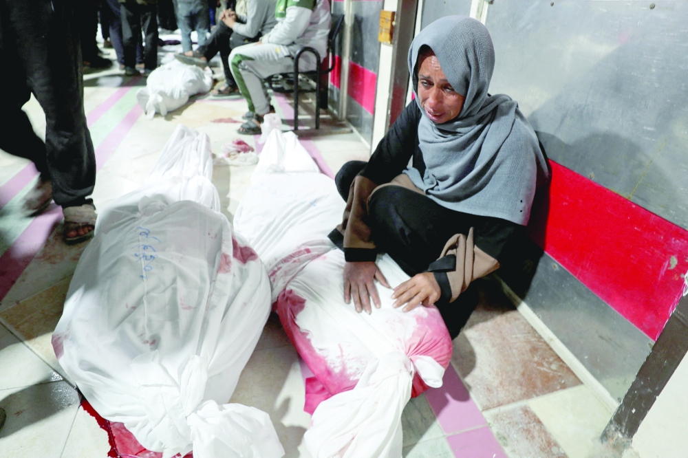A Palestinian woman mourns loved ones killed in Israeli strikes in Beit Lahiya on Thursday. — Reuters