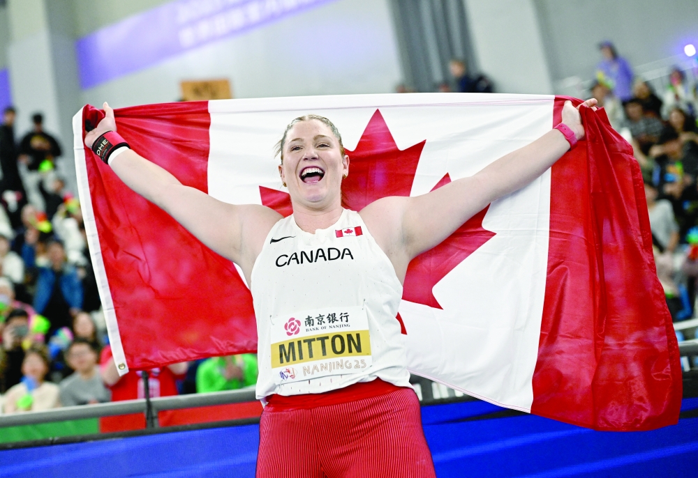 Canada's Sarah Mitton celebrates winning the Women's Shot Put Final.