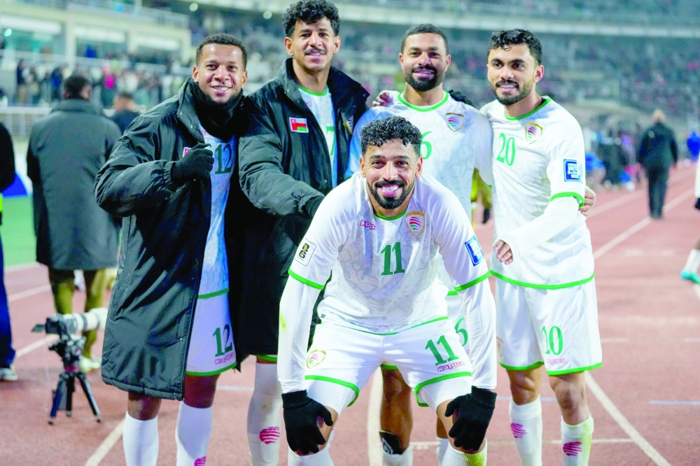 Oman players celebrate after the match.