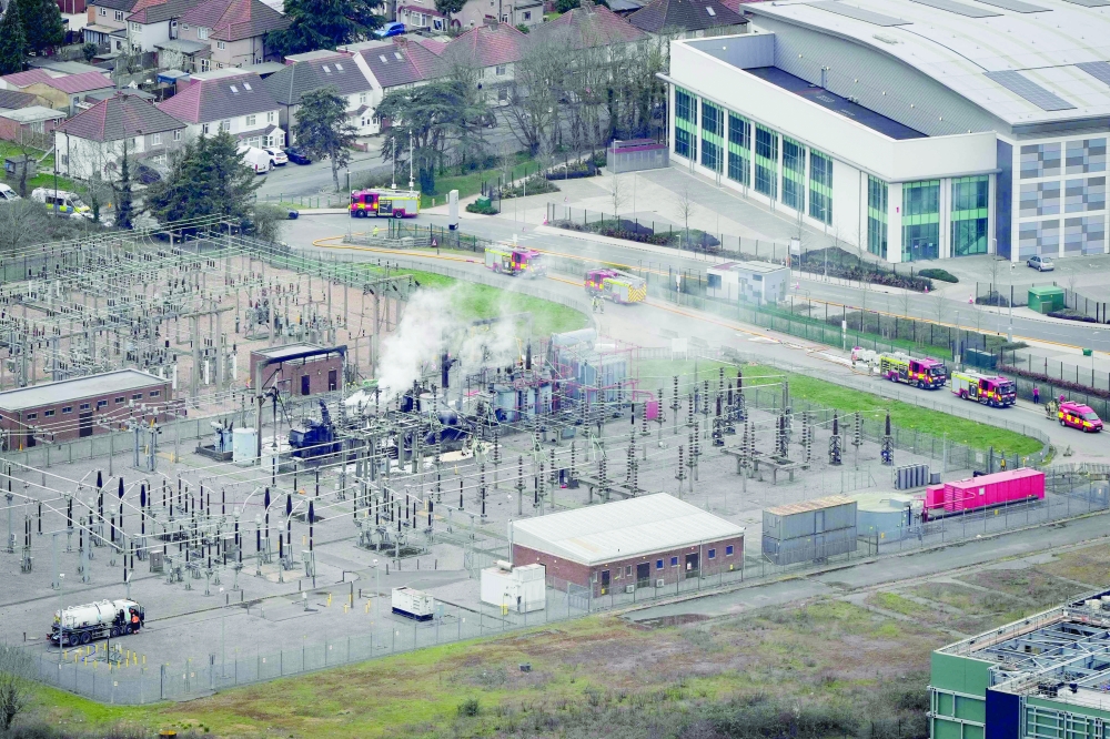 Smoke billows from a substation supplying power to Heathrow Airport amid efforts to douse the remainder of the flames after a fire broke out in Hayes, west London. — AFP