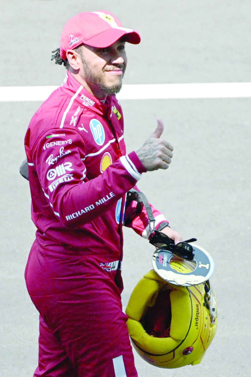 Ferrari's British driver Lewis Hamilton celebrates after winning the sprint race of the Formula One. — AFP