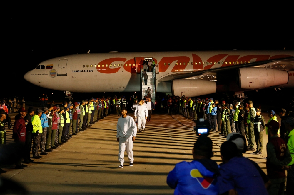 Venezuelan migrants walk following their arrival on a flight, in Caracas, Venezuela. — Reuters