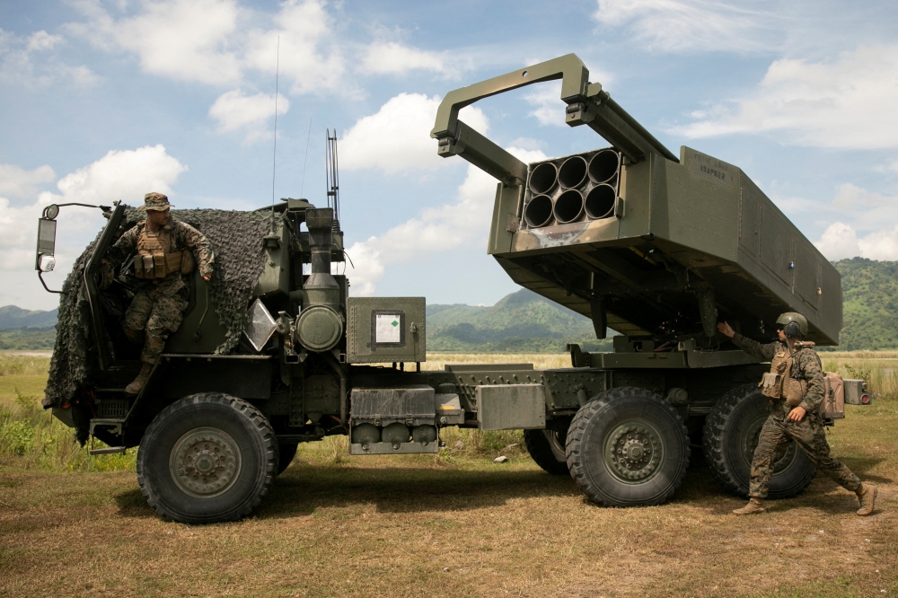US Marines check the M142 High Mobility Artillery Rocket System (HIMARS) after the live fire exercises, in Tarlac province. — Reuters