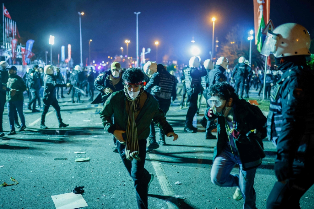 Turkish anti-riot police officers stand to disperse protesters gathering, in Istanbul. — AFP