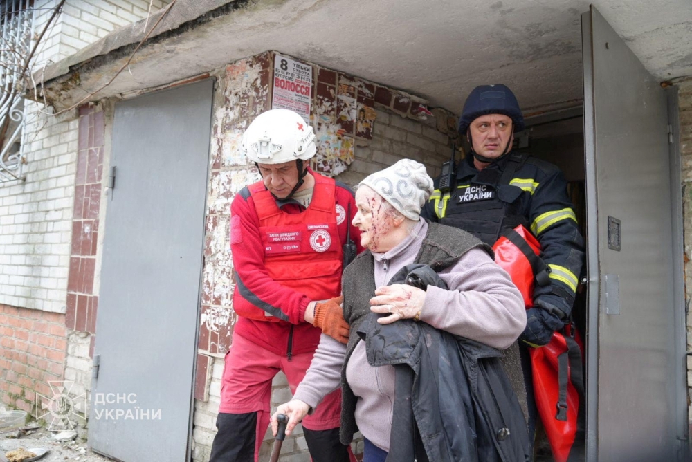 A medical worker evacuates a wounded person from an apartment building damaged during a Russian missile strike in Sumy, Ukraine, on Monday. - Reuters