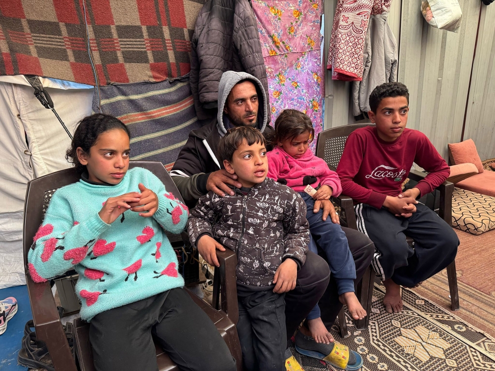 Ahmad al-Sayyed, who fled Rafah in the Gaza Strip with his four children, in a relative’s tent in western Khan Younis, Gaza Strip, March 24, 2025. (Bilal Shbair/The New York Times)
