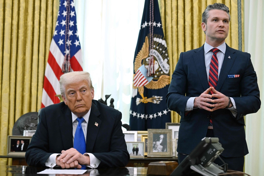 (FILES) US President Donald Trump listens as Secretary of Defense Pete Hegseth speaks during an event in the Oval Office of the White House in Washington, DC. — AFP