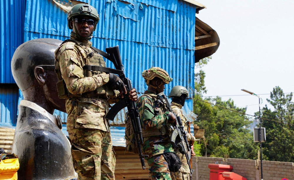 Members of the M23 rebel group stand guard, in Bukavu. — Reuters