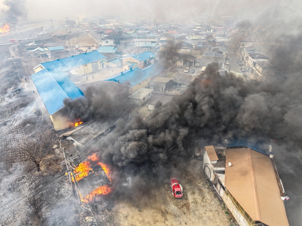 Houses catch fire as a wildfire devastates the area, in Uiseong, South Korea. — Reuters 