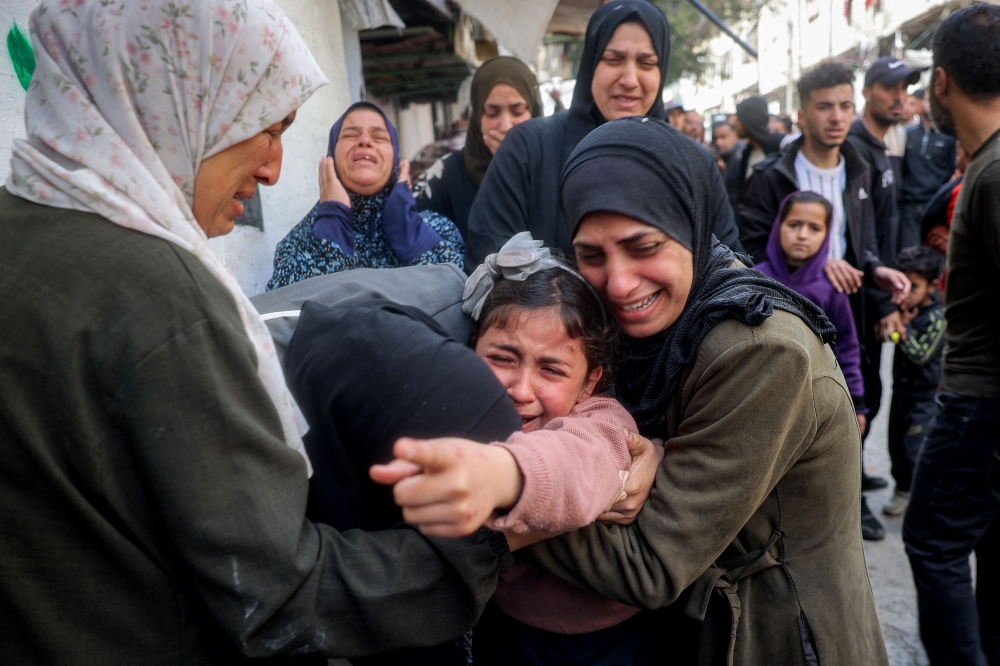 Palestinians mourn members from the Abu al-Rous family during the funeral at the Bureij. — AFP
