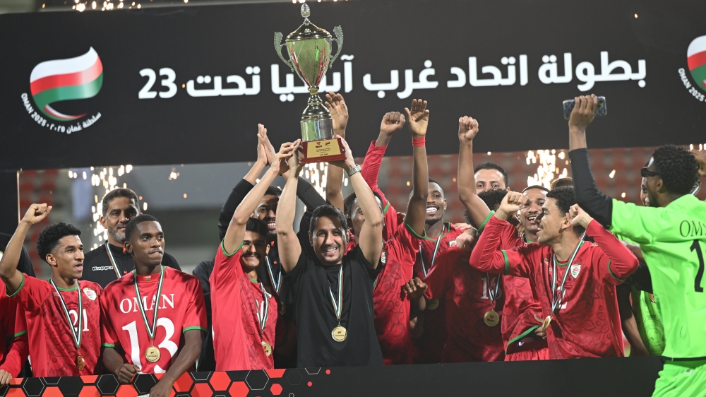 Oman players celebrate the championship trophy 