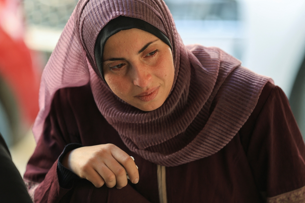 A mourner reacts next to the bodies of Palestinians killed in Israeli strikes, at Al-Ahli Arab Baptist hospital, in Gaza City, March 26, 2025. REUTERS/Dawoud Abu Alkas