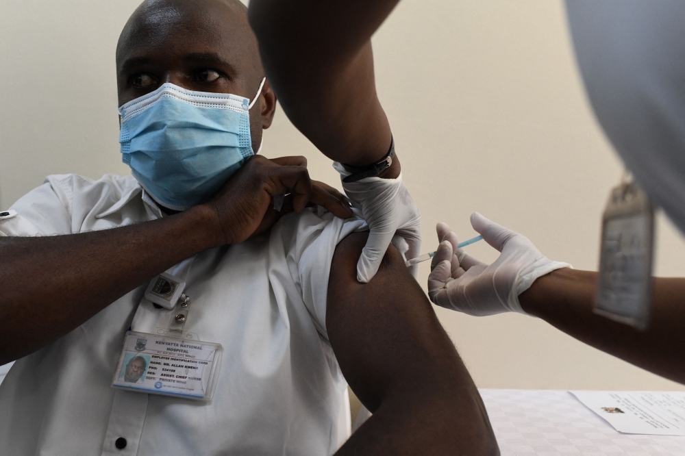 A Kenyan health worker receives a dose of the Oxford/AstraZeneca vaccine, part of the COVAX mechanism by GAVI, to fight against Covid-19 at the Kenyatta National Hospital in Nairobi. - AFP

