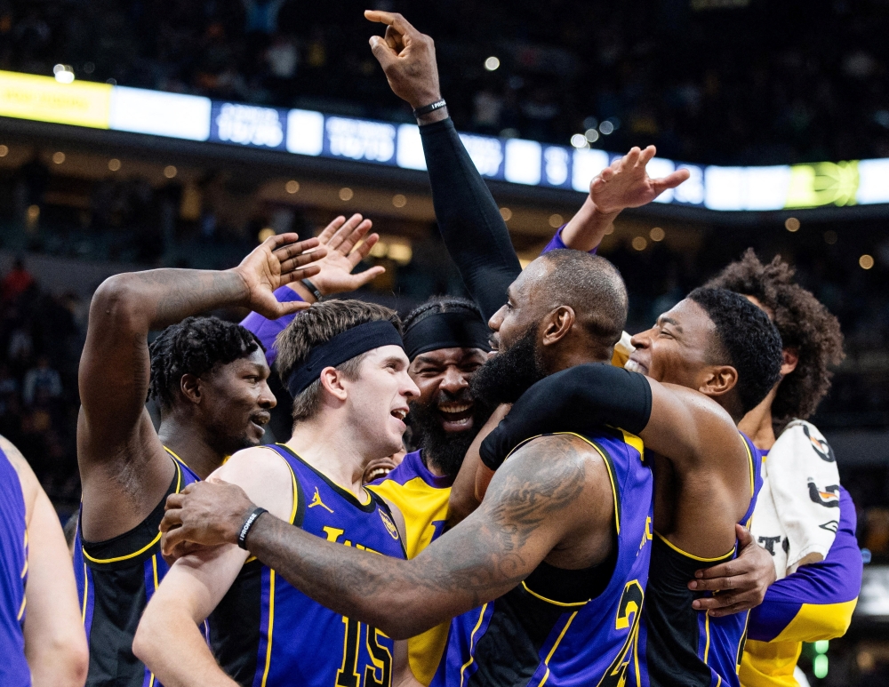 Mar 26, 2025; Indianapolis, Indiana, USA; Los Angeles Lakers forward LeBron James (23) celebrates his game winning shot against the Indiana Pacers with teammates at Gainbridge Fieldhouse. Mandatory Credit: Trevor Ruszkowski-Imagn Images     TPX IMAGES OF THE DAY
