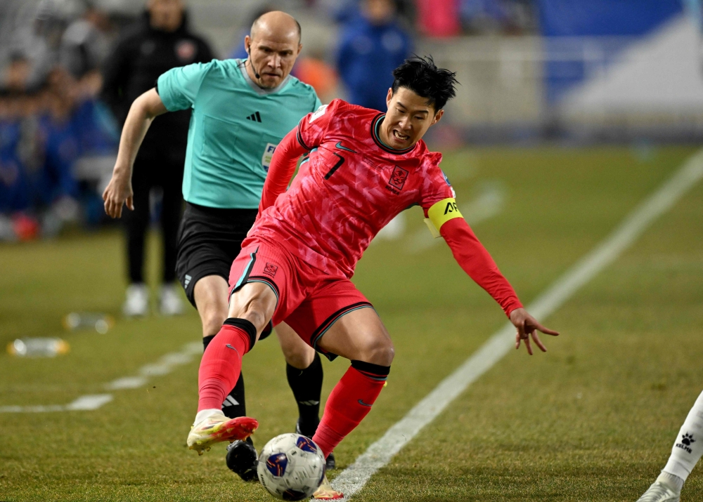 South Korea's Son Heung-min controls the ball on the touchline against Jordan during the World Cup 2026 Asian qualifier football match between South Korea and Jordan in Suwon on March 25, 2025.  (Photo by Jung Yeon-je / AFP)

