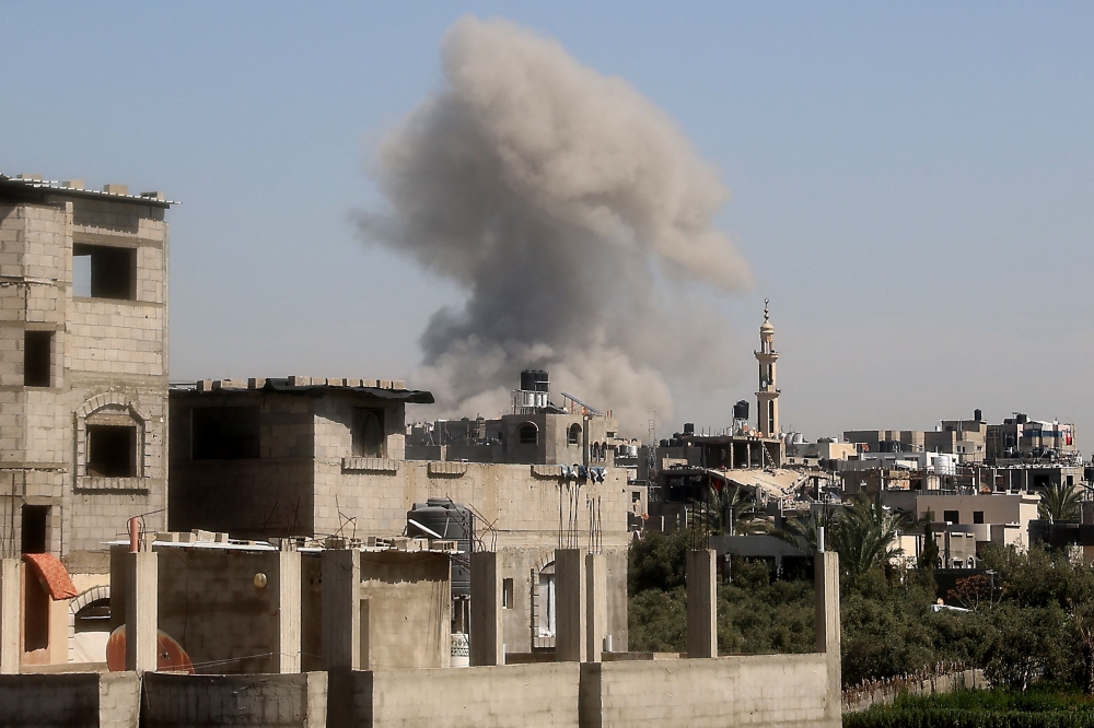 Smoke billows from an Israeli strike at Bureij camp in the central Gaza Strip, on Thursday. — AFP