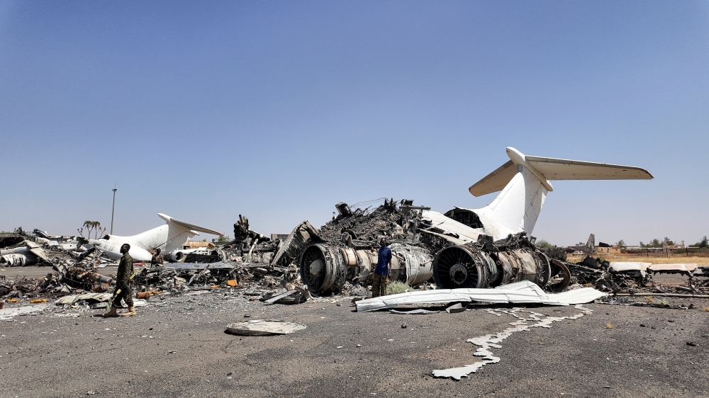 Members of Sudanese army walk next to destroyed planes' wreckages on the tarmac at Khartoum Airport, after the Sudanese army deepened its control over the capital Khartoum, from the Rapid Support Forces (RSF), in Khartoum, Sudan. - Reuters
