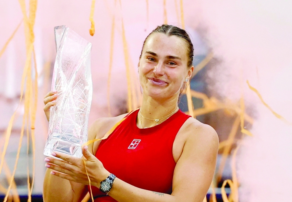 Aryna Sabalenka celebrates with the Butch Buchholz trophy after her match against Jessica Pegula in the women's singles championship of the Miami Open at Hard Rock Stadium. — Reuters