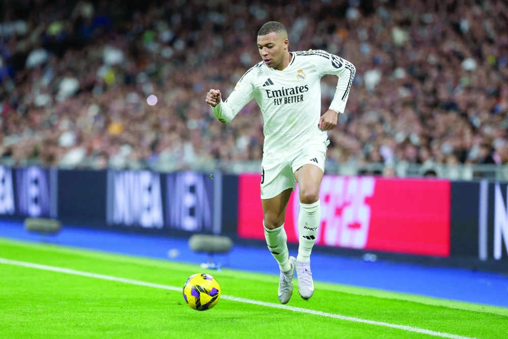 Real Madrid's French forward Kylian Mbappe runs with the ball during the Spanish league football match between Real Madrid CF and Club Deportivo Leganes. — AFP