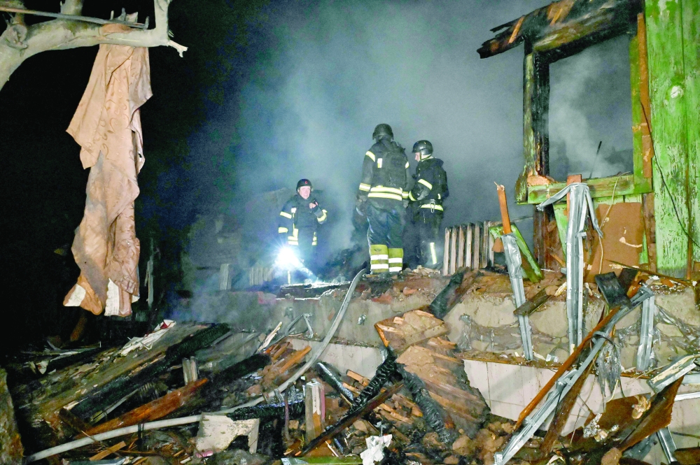 Rescuers inspect the rubble of the building following a drone attack in Kharkiv. — AFP