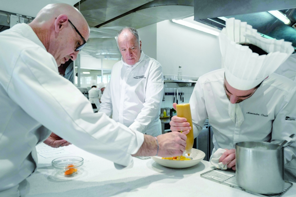 French Chef Patrick Henriroux works in the kitchen of 'La Pyramide' restaurant in Vienne. — AFP