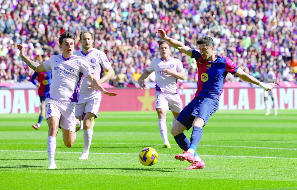 FC Barcelona's Robert Lewandowski in action with Girona's Alejandro Francis. — Reuters