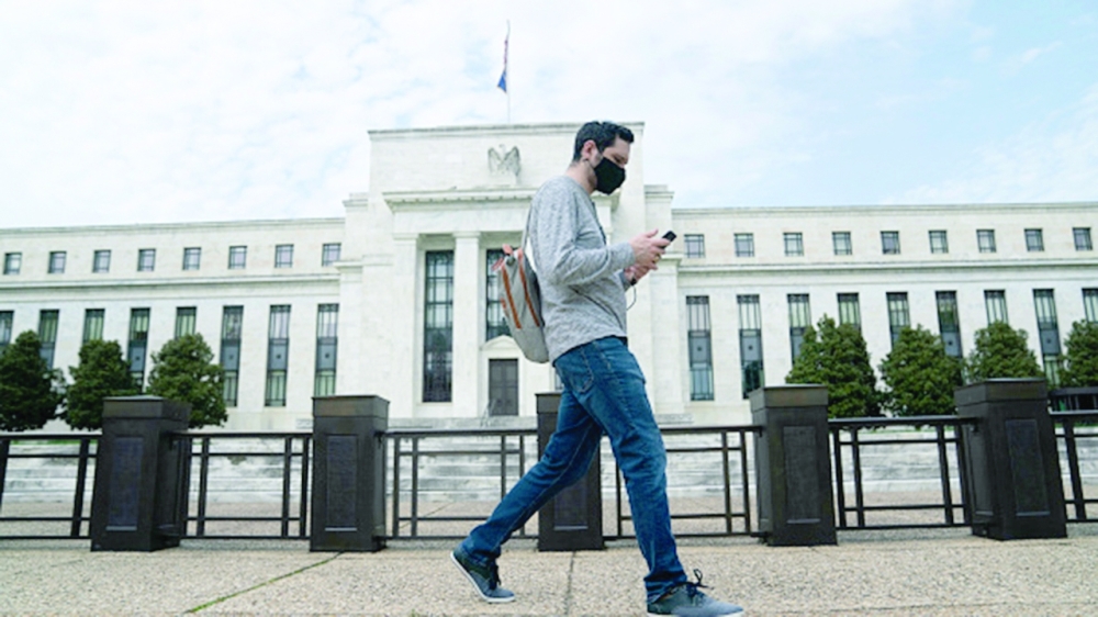 A man walks past the US Federal Reserve building in Washington DC. — AFP