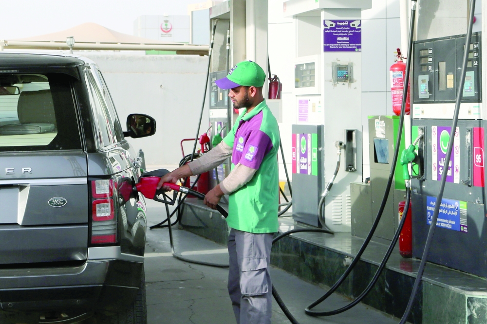 A worker fills a vehicle with petrol at a gas station in Riyadh, Saudi Arabia. — Reuters