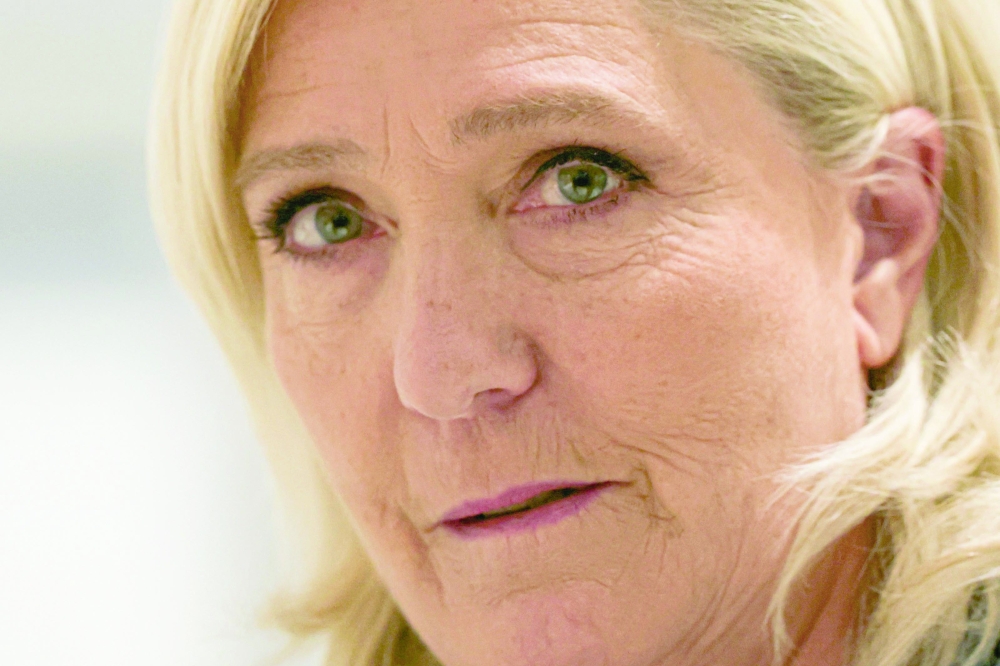 Marine Le Pen arrives at the Paris courthouse for her trial verdict on suspicion of embezzlement of European public funds, in Paris, on Monday. — AFP