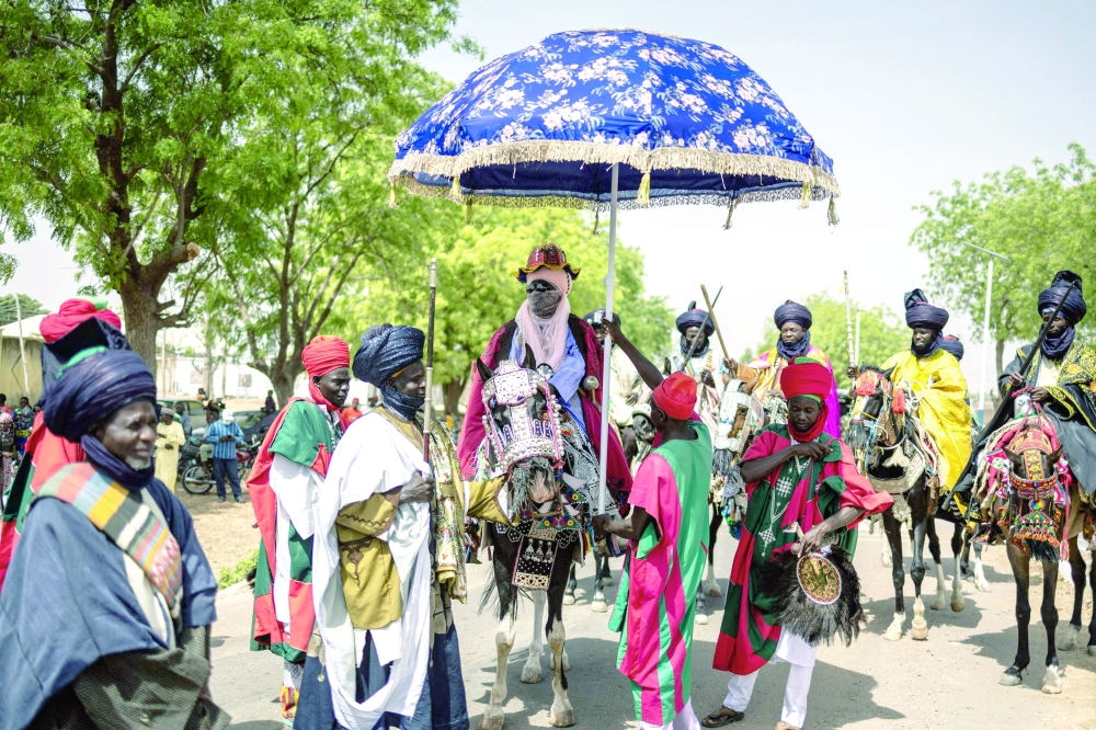 Muhammad Hameen Nuhu Sunusi (C), Emir of Dutse, rides during the Durbar horse procession in Dutse. — AFP