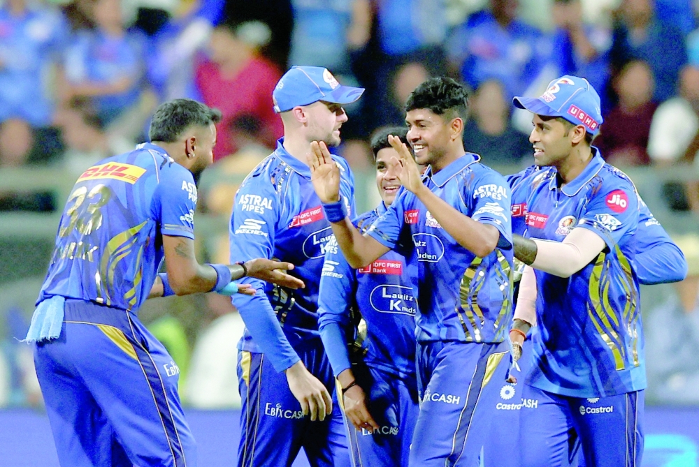 Cricket - Indian Premier League - IPL - Mumbai Indians v Kolkata Knight Riders - Wankhede Stadium, Mumbai, India - March 31, 2025 Mumbai Indians' Ashwani Kumar celebrates with teammates after taking the wicket of Kolkata Knight Riders' Andre Russell REUTERS/Francis Mascarenhas

