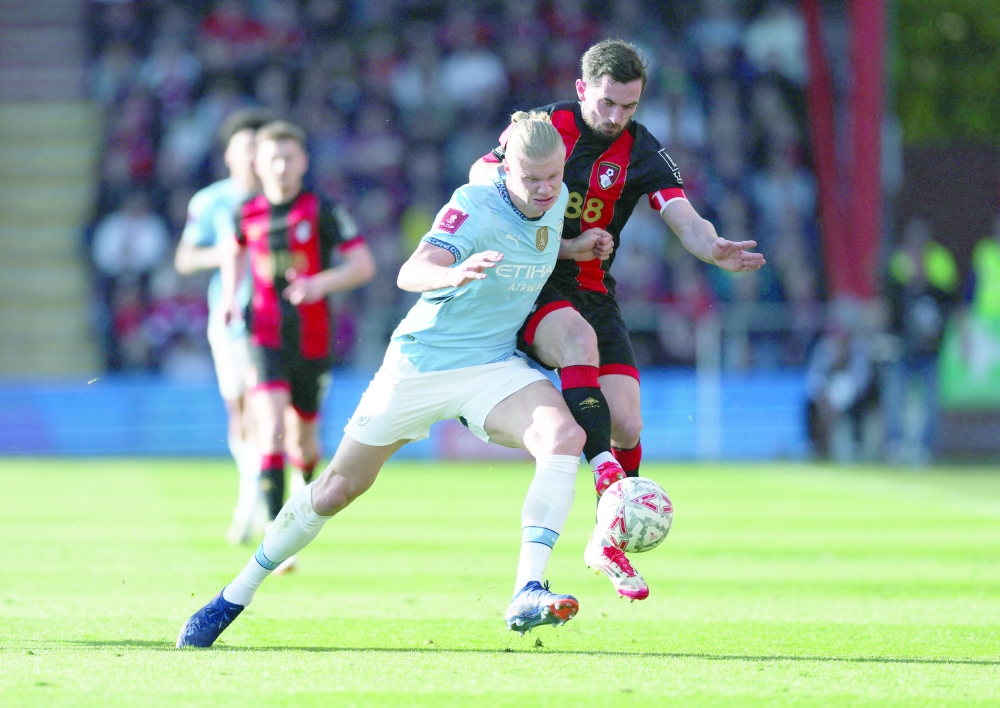 Soccer Football - FA Cup - Quarter Final - AFC Bournemouth v Manchester City - Vitality Stadium, Bournemouth, Britain - March 30, 2025 Manchester City's Erling Haaland in action with AFC Bournemouth's Lewis Cook REUTERS/Hannah Mckay
