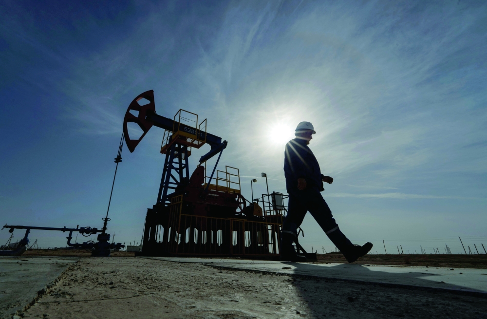 A worker walks during operations of a drilling rig at Zhetybay field in the Mangystau region, Kazakhstan. — Reuters