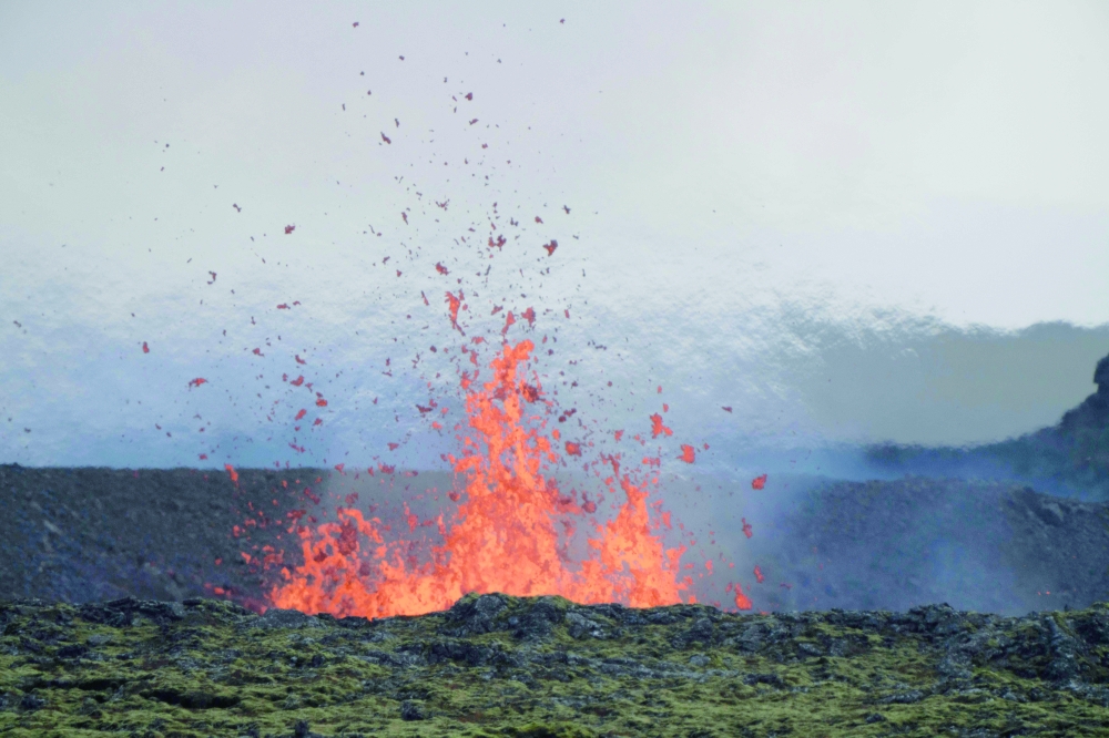 Molten lava is seen coming out of a fissure on the outskirts of Grindavik on Tuesday. — AFP