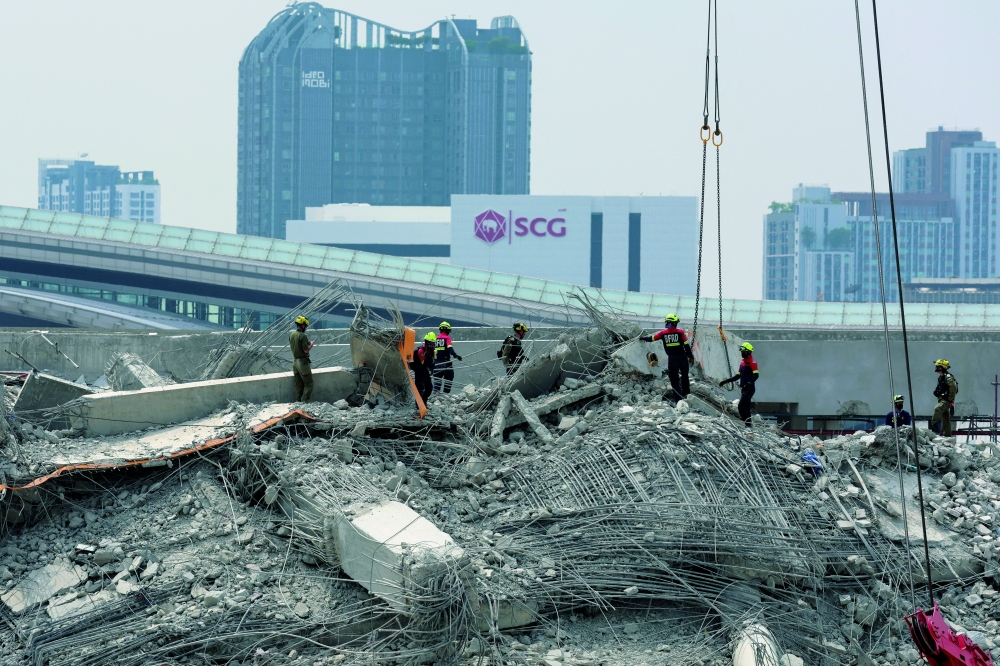 Rescue workers operate at the site of a collapsed building, following a strong earthquake, in Bangkok, Thailand, on Tuesday. — Reuters
