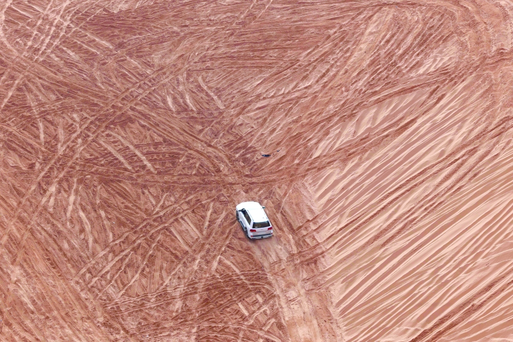 A Saudi driver drives his car up a dune in the Quseiba area, in the Az Zulfi desert. — AFP