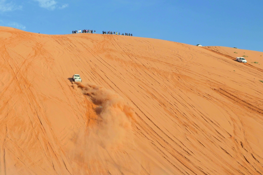 A Saudi driver drives his car up a dune in the Quseiba area, in the Az Zulfi desert. — AFP