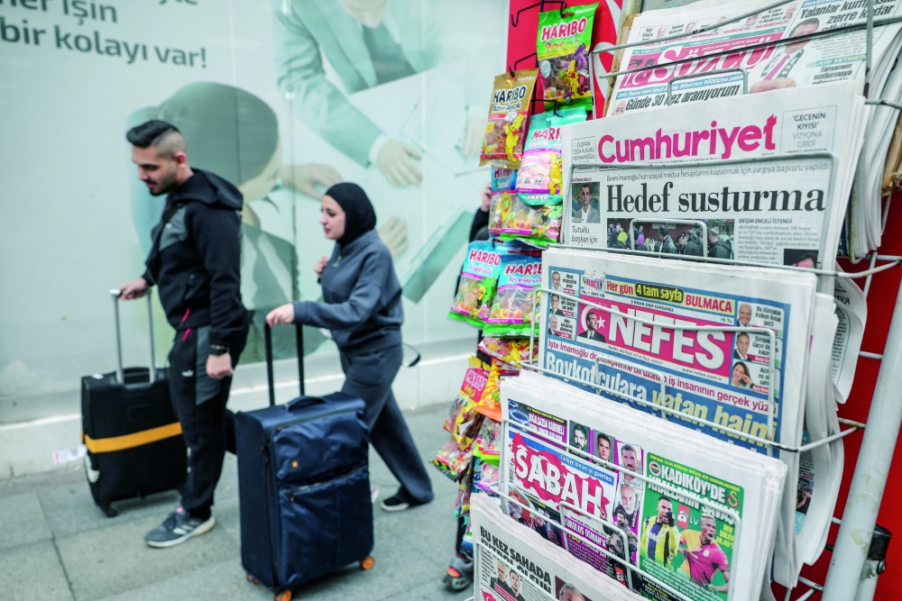 People walk by newsstand, amid the opposition's calls for a mass economic boycott following the arrest of Istanbul Mayor Ekrem. — Reuters