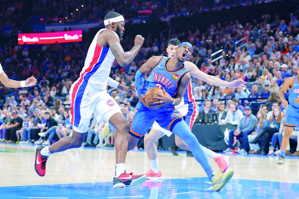 Oklahoma City Thunder guard Shai Gilgeous-Alexander (2) drives to the basket beside Detroit Pistons forward Paul Reed (7) during the second half at Paycom Center. Mandatory Credit: Alonzo Adams-Imagn Images