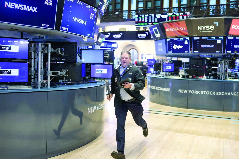 A trader runs on the floor of the New York Stock Exchange (NYSE) at the opening bell in New York City. - AFP