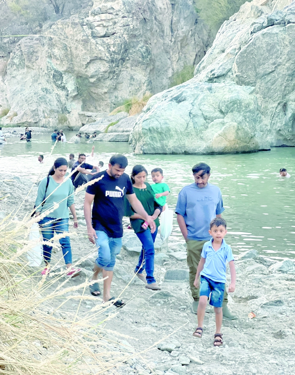 Children splashing in the pools, families enjoying picnics and barbecues