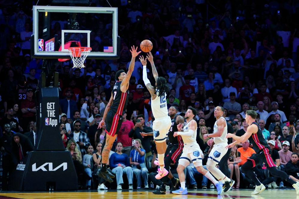 Memphis Grizzlies guard Ja Morant (12) shoots and scores the game-winning shot over Miami Heat center Kel'el Ware (7) during the fourth quarter at Kaseya Center. — Imagn Images