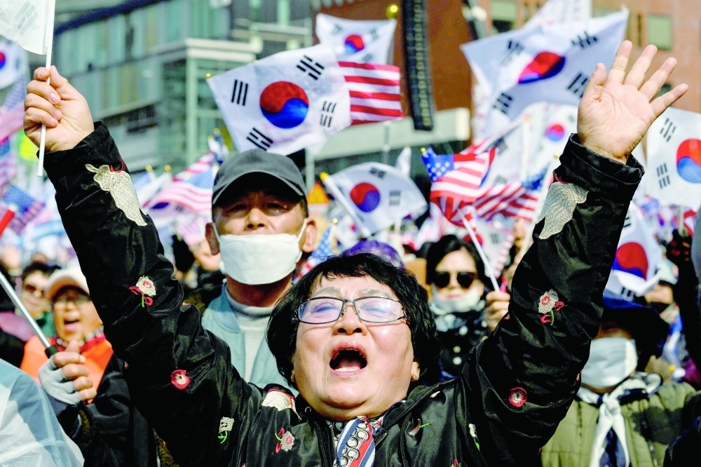 Supporters of South Korea president Yoon Suk Yeol react prior to the announcement of the Constitutional Court's verdict on Yoon's impeachment outside the presidential residence in Seoul. — AFP
