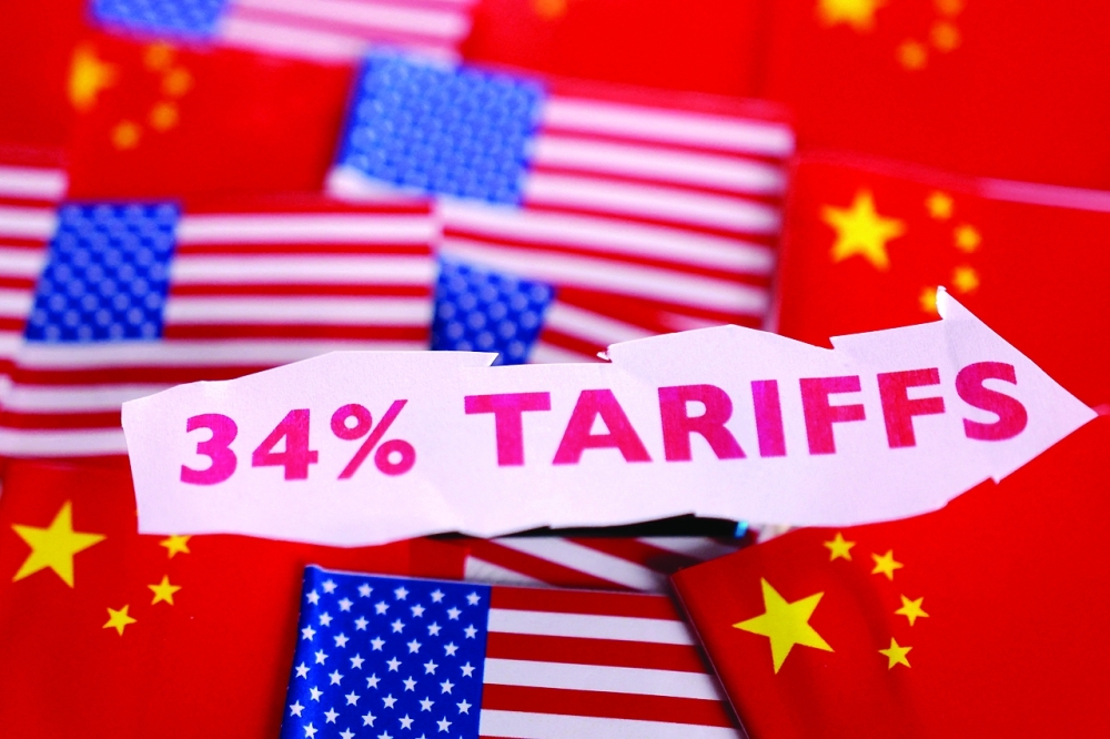 US and Chinese flags and a label with the word "34% Tariffs" are seen in this illustration. — Reuters