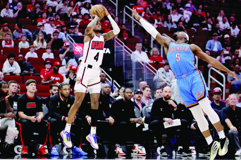 Houston Rockets guard Jalen Green (4) shoots outside against Oklahoma City Thunder guard Luguentz Dort (5) during the first quarter at Toyota Center. Mandatory. — Reuters
