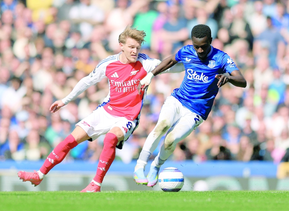 Arsenal's Martin Odegaard in action with Everton's Idrissa Gueye. — Reuters